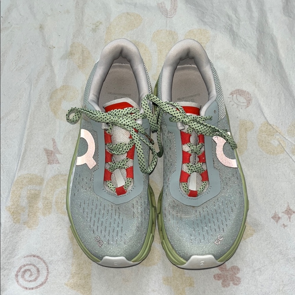 On Running Green and Red Athletic Shoes